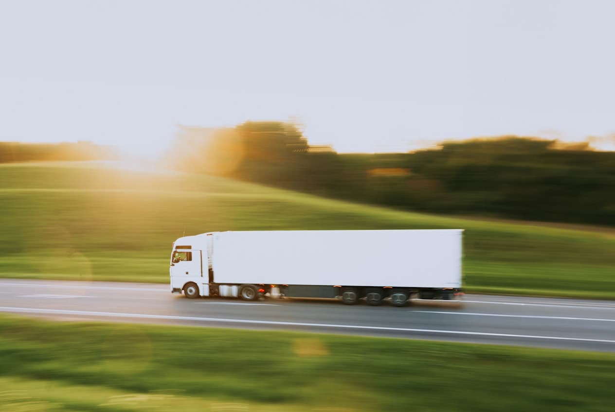 Crutchfield Movers long-distance moving truck on a highway at sunset